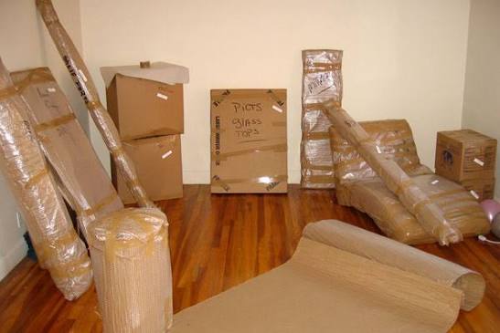 Wrapped furniture prepared for careful residential relocation